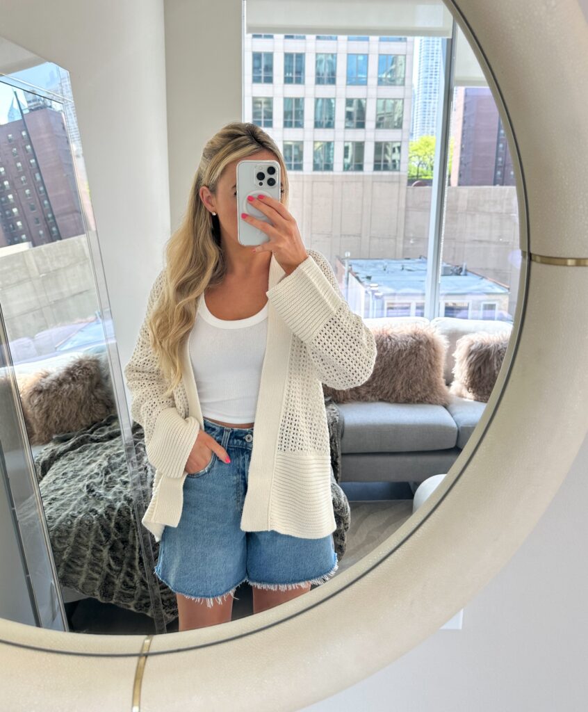 beach day outfit with denim shorts and summer cardigan